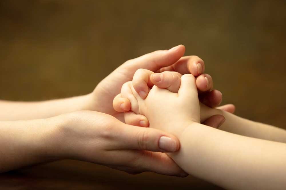 Beba i mama se drže za ruke
